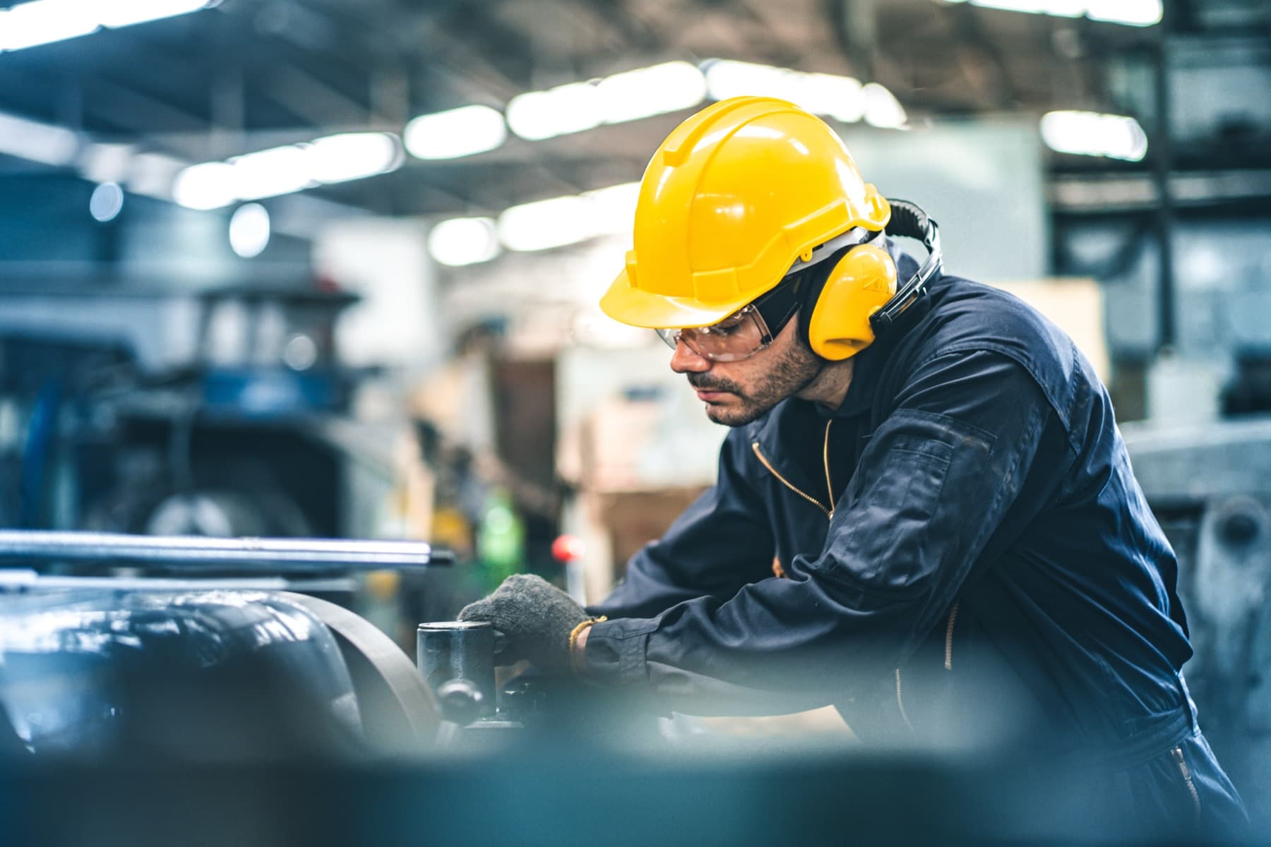 Worker using precision tools in a fabrication workshop